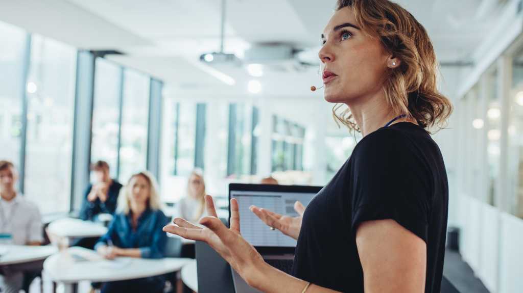 woman presenting to colleagues students