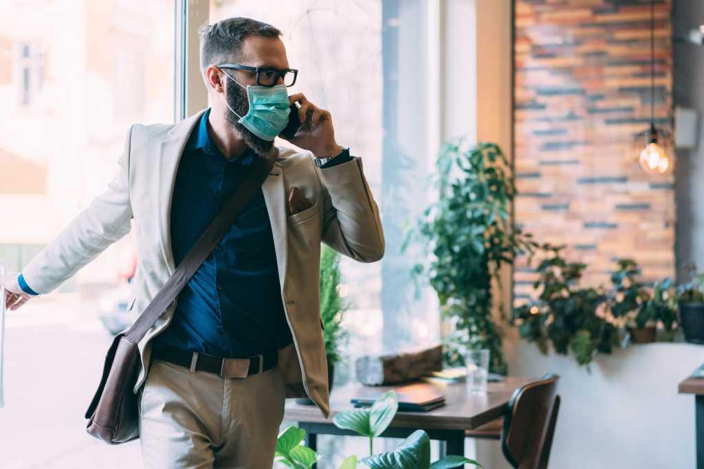 man with mask office after covid coronavirus social distancing by martin dm getty images