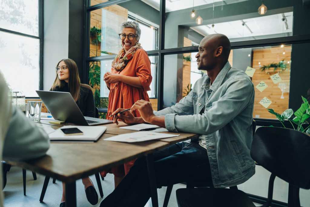 Happy businesspeople having a meeting in a creative office. Group of cheerful businesspeople working as a team in a multicultural workplace.