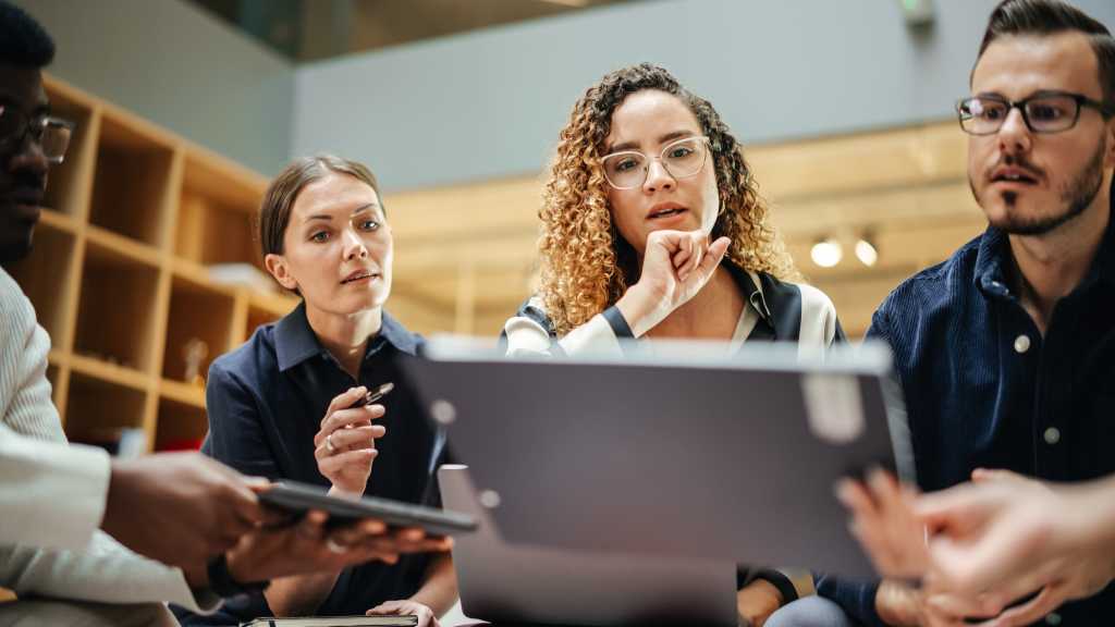 Female Manager Leading a Meeting About Sustainability and Ethnicity with her Multiethnic Teammates. Young Group of Employees Presenting Their Project Ideas To Startup CEO. Medium Shot