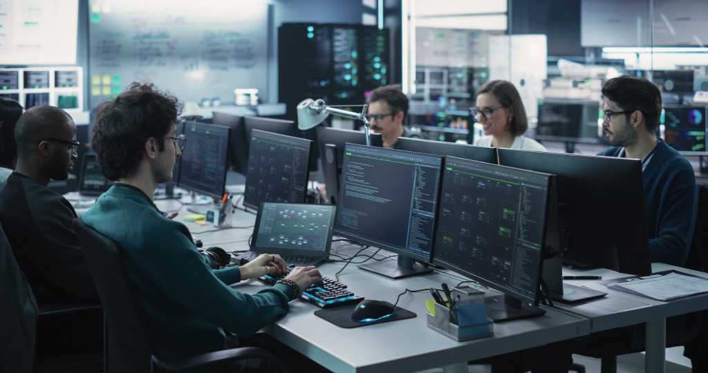 Group of Empowered Multicultural Men and Women Working in a Research Center, Using Computers to Run Advanced Software, Develop Artificial Intelligence Interface and Cyber Security Protocols