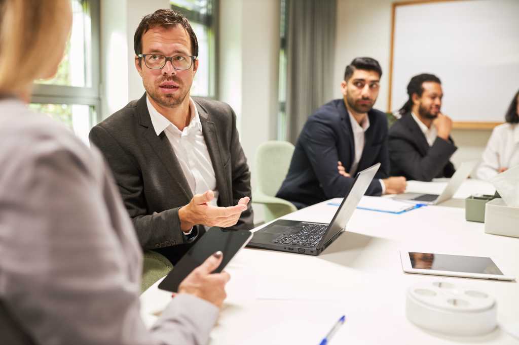 Business man as a consultant in a meeting in the consulting workshop in the office at the conference table