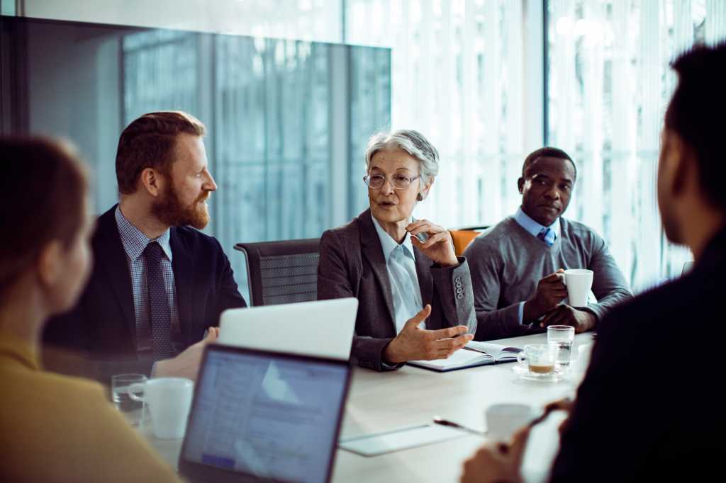 Professional Meeting: Senior Businesswoman and Colleague in Discussion