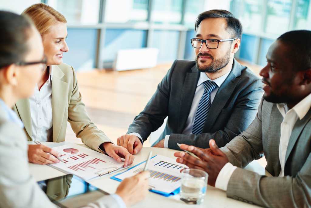 Confident businessman looking at his colleagues at meeting