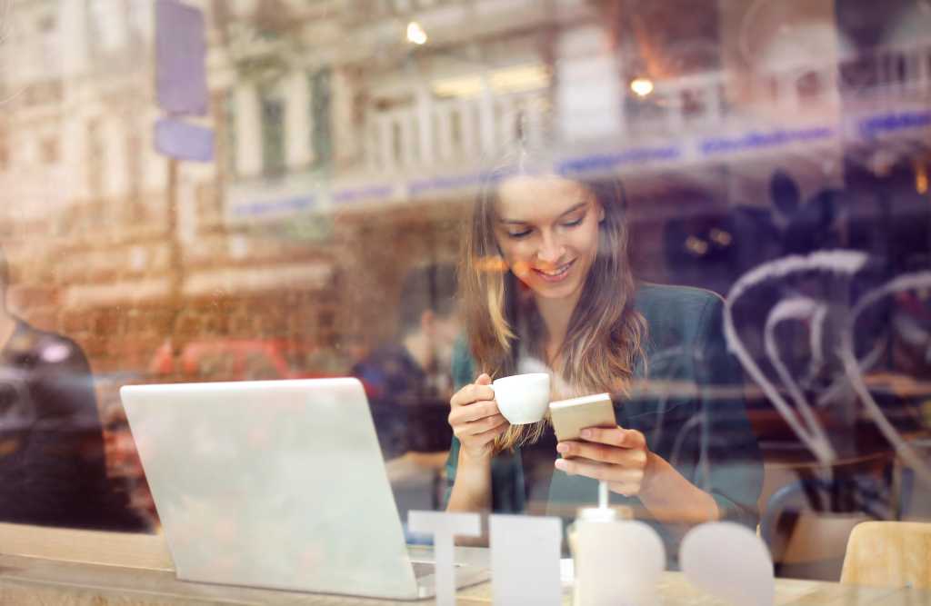 Woman at the cafeteria using technology