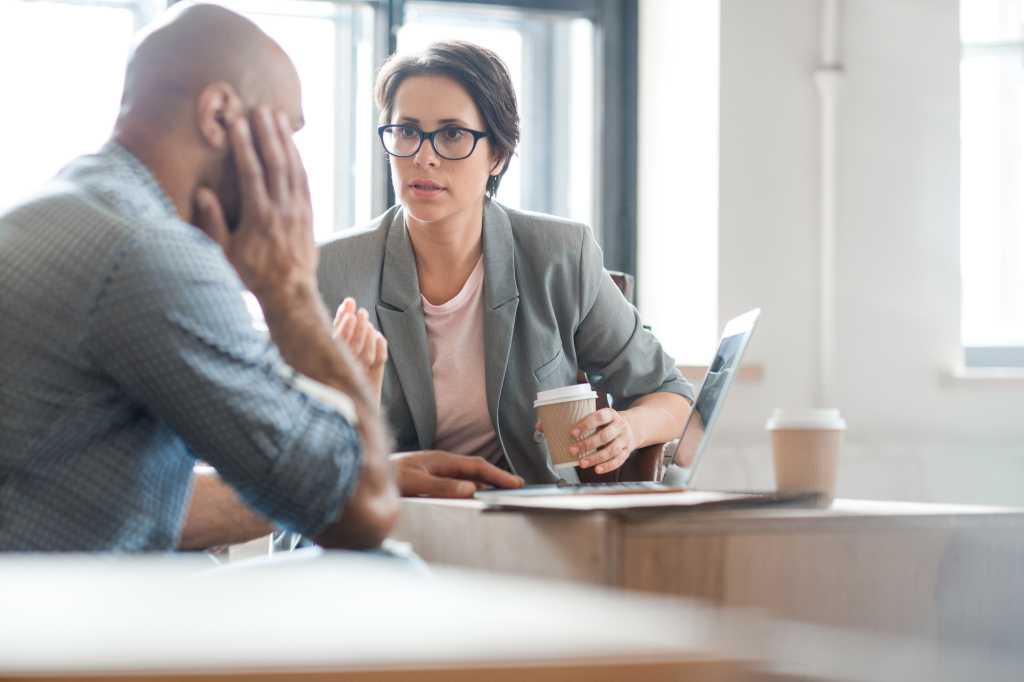 Two financial managers discussing their achievements and problems at break